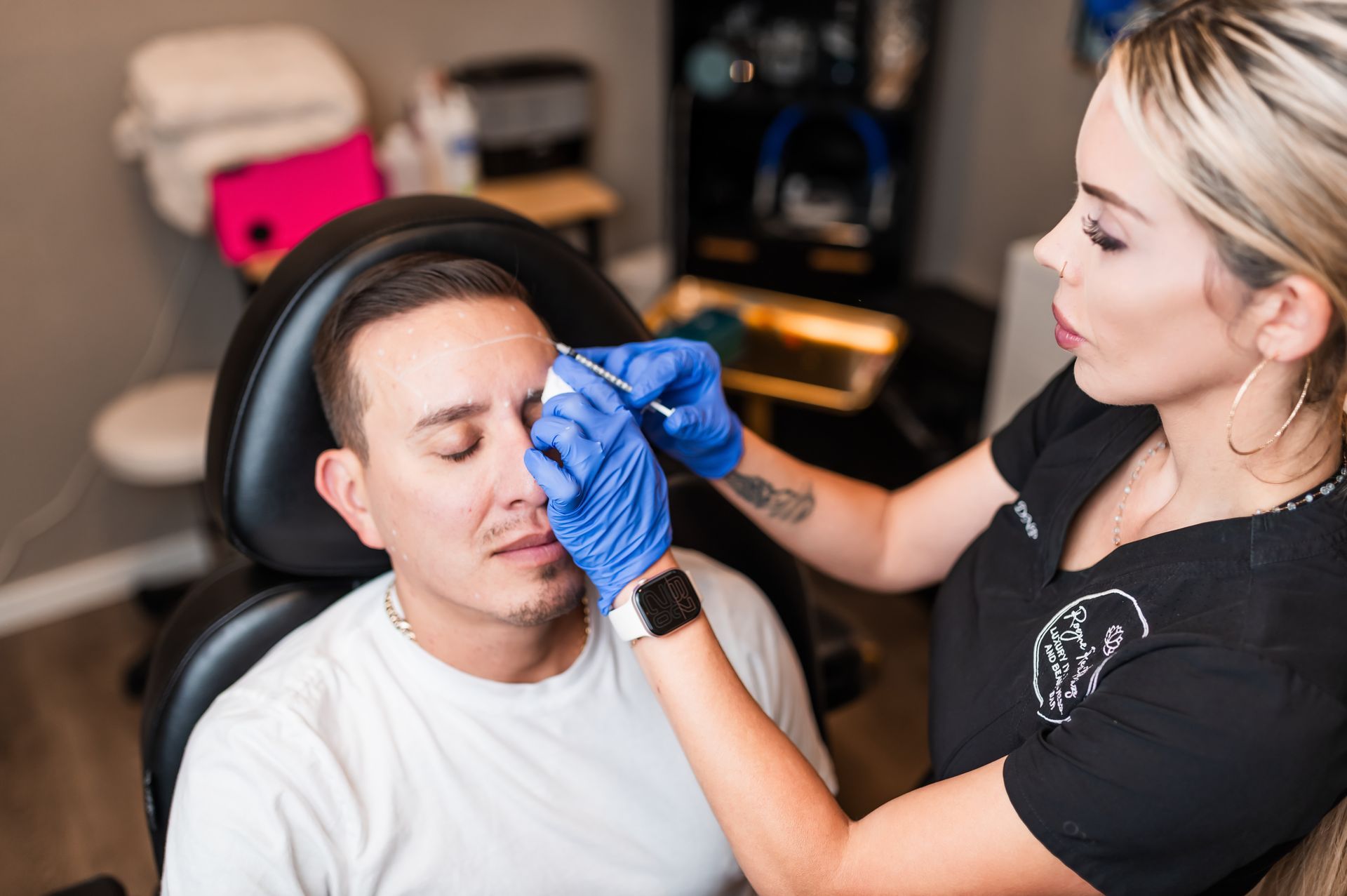 A woman is getting a botox injection in her eye.