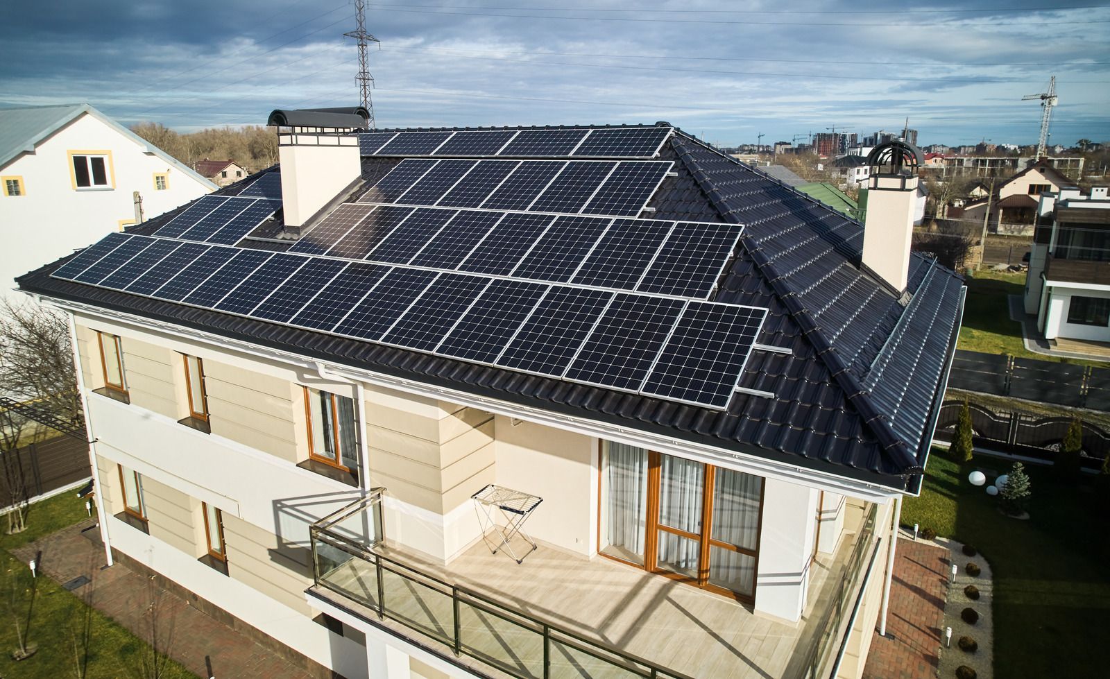House with solar panels on roof and satellite dish.