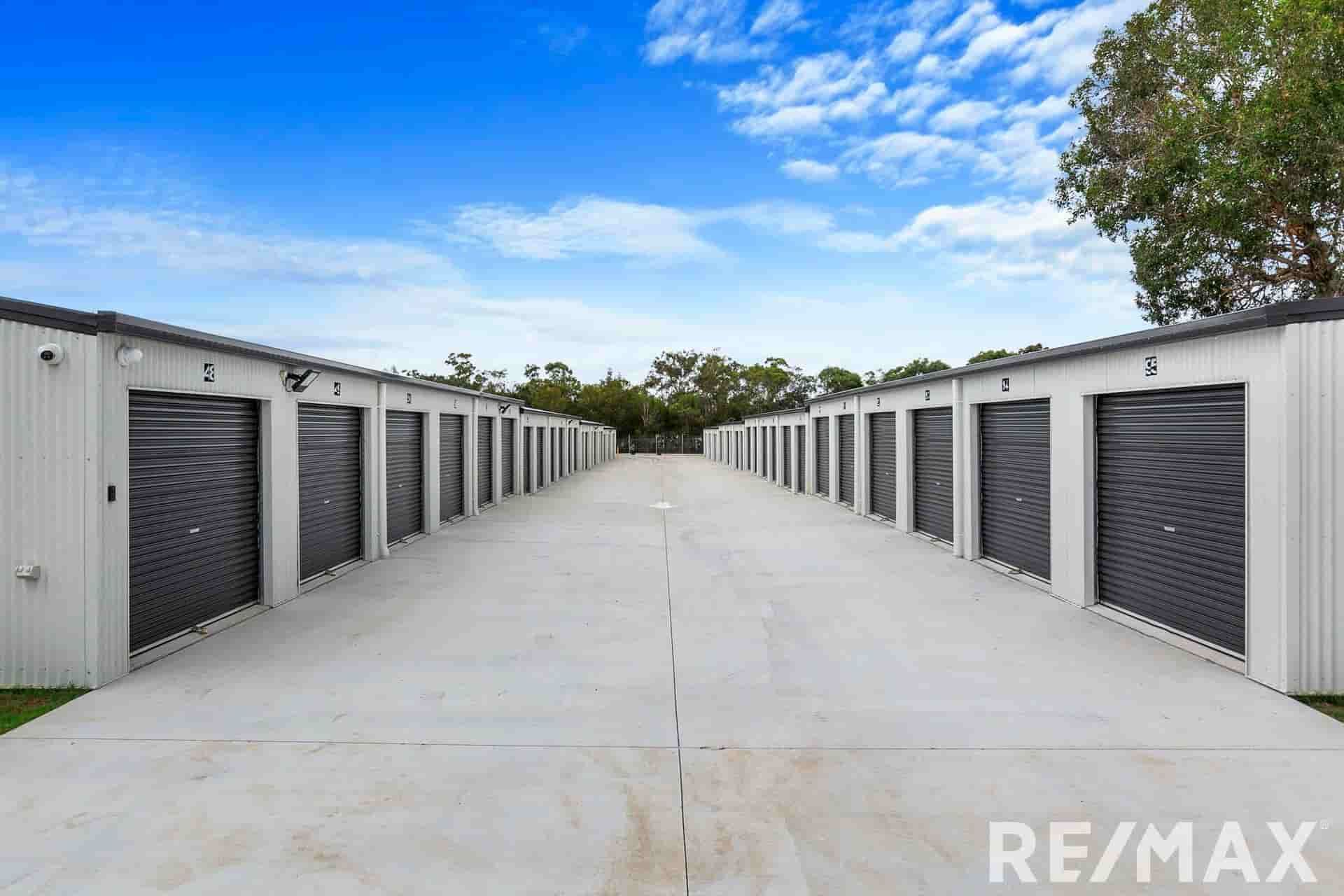 A row of storage units are lined up in a parking lot — The Bay Self Storage In Urangan, QLD