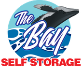The Bay Self Storage logo with a whale tail, blue waves, and red text on white background