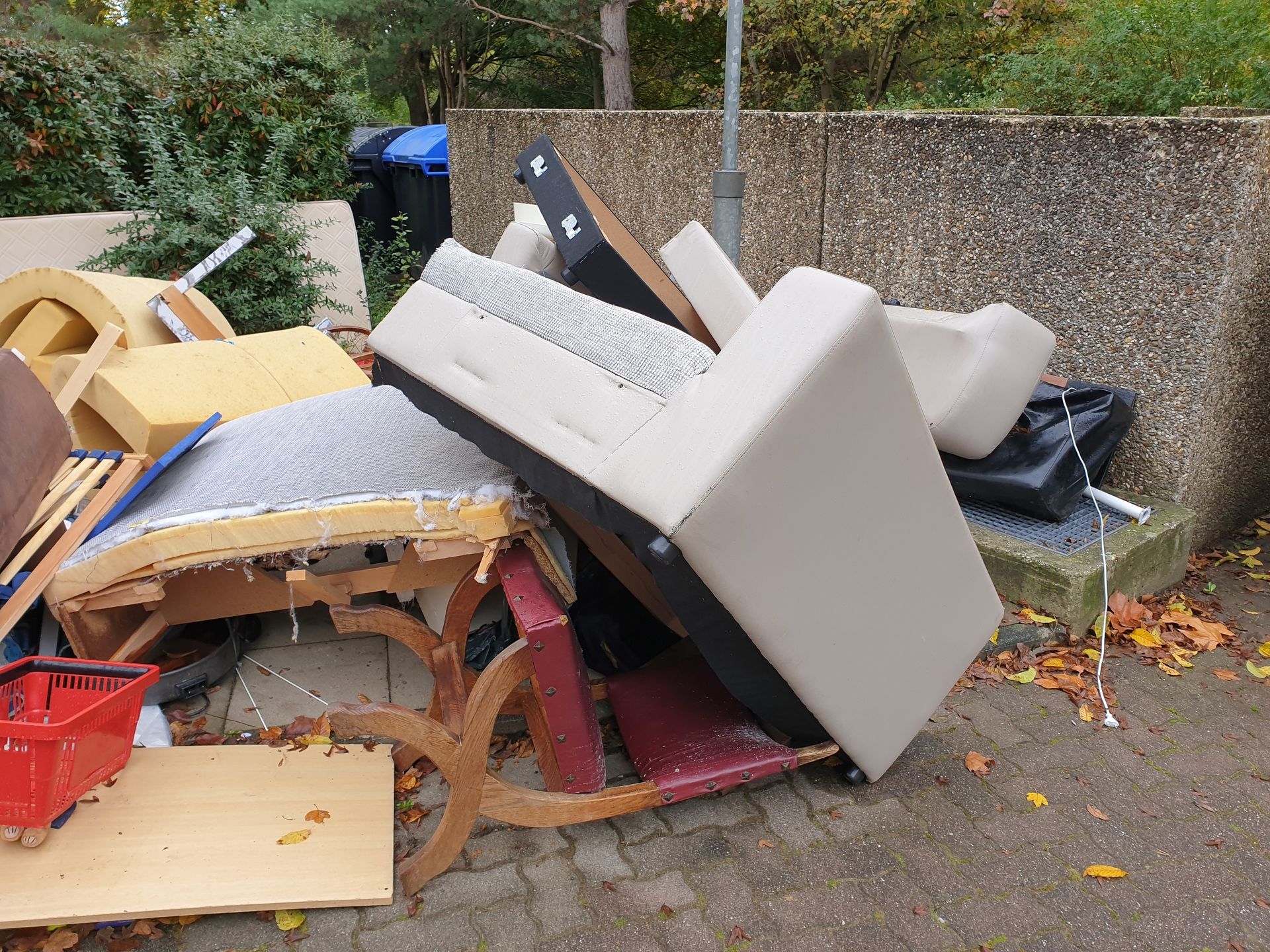 A pile of furniture is sitting on the side of the road.