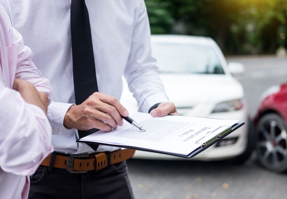 Insurance Agent Explaining Car Insurance Coverage to Car Owner