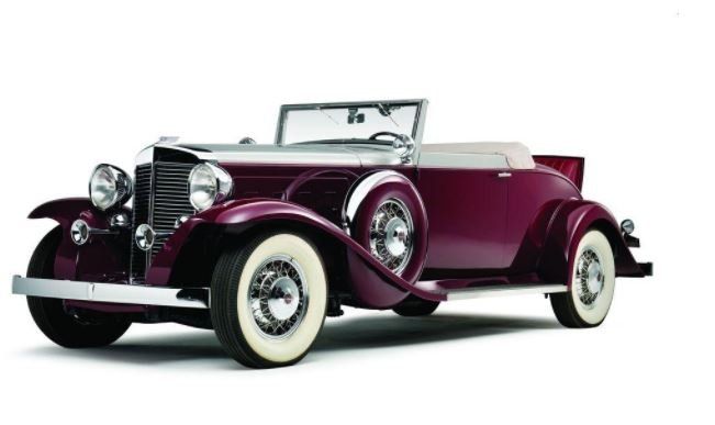 a burgundy convertible with white tires on a white background