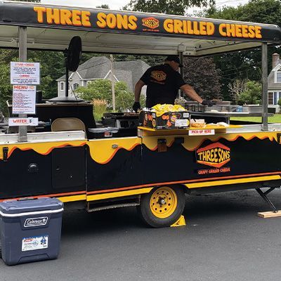 a three sons grilled cheese truck is parked on the side of the road