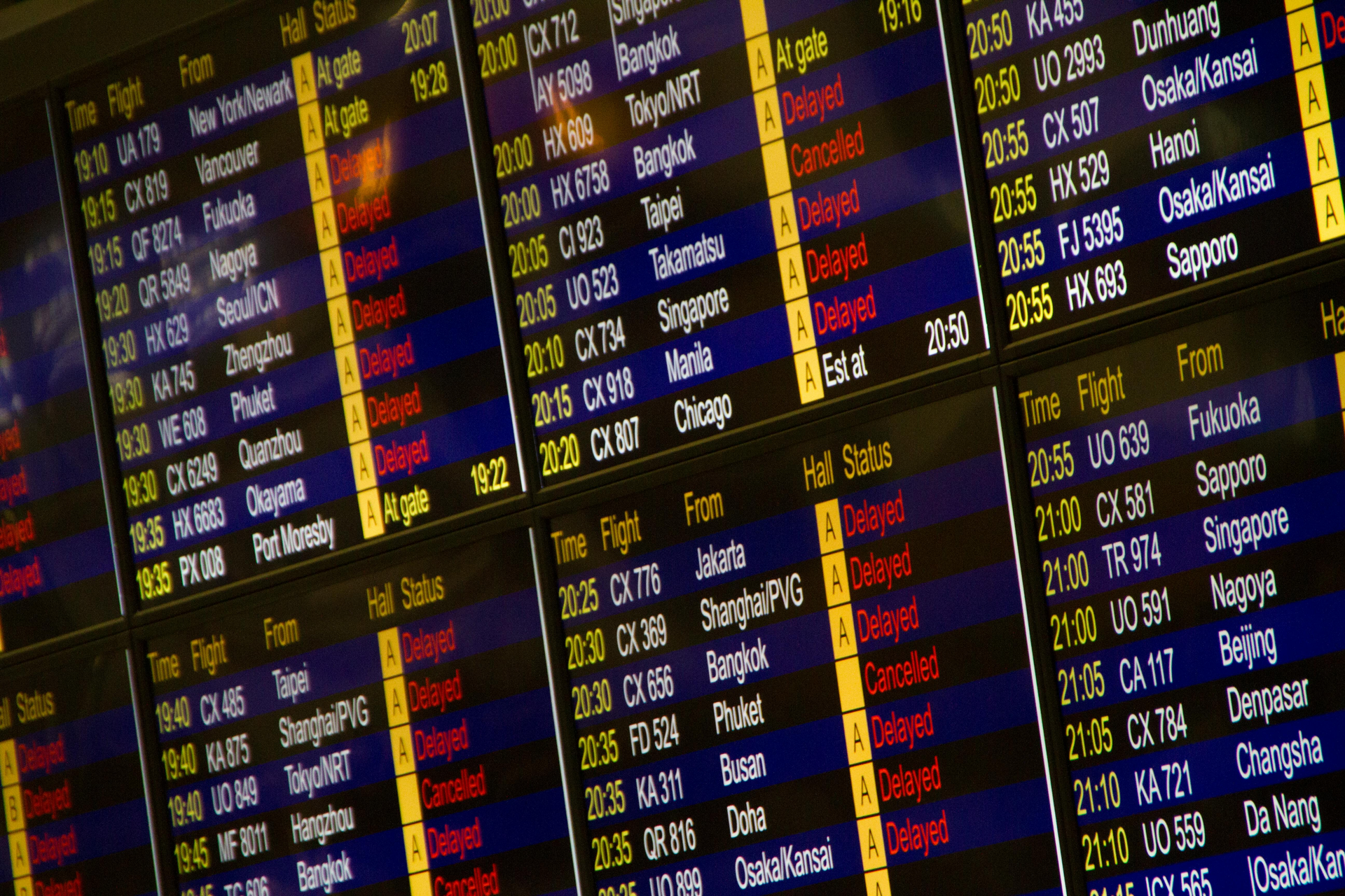 A large screen displays a list of flights including one from bangkok