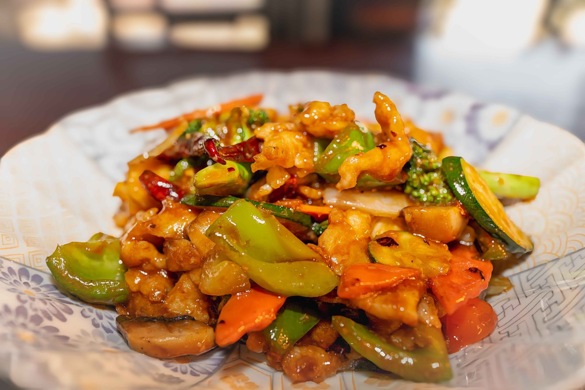 Colorful stir-fried vegetables and chicken served on a white plate