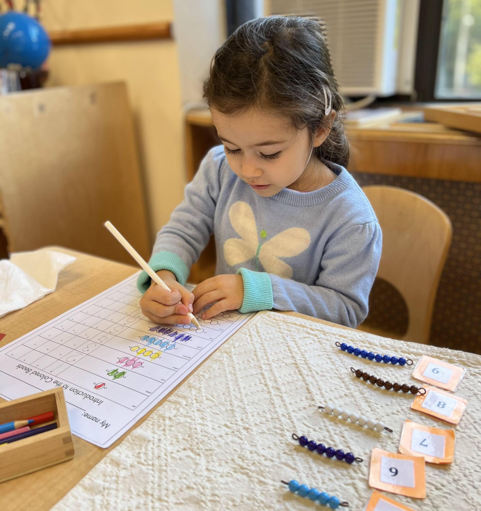 Child working with Montessori math materials