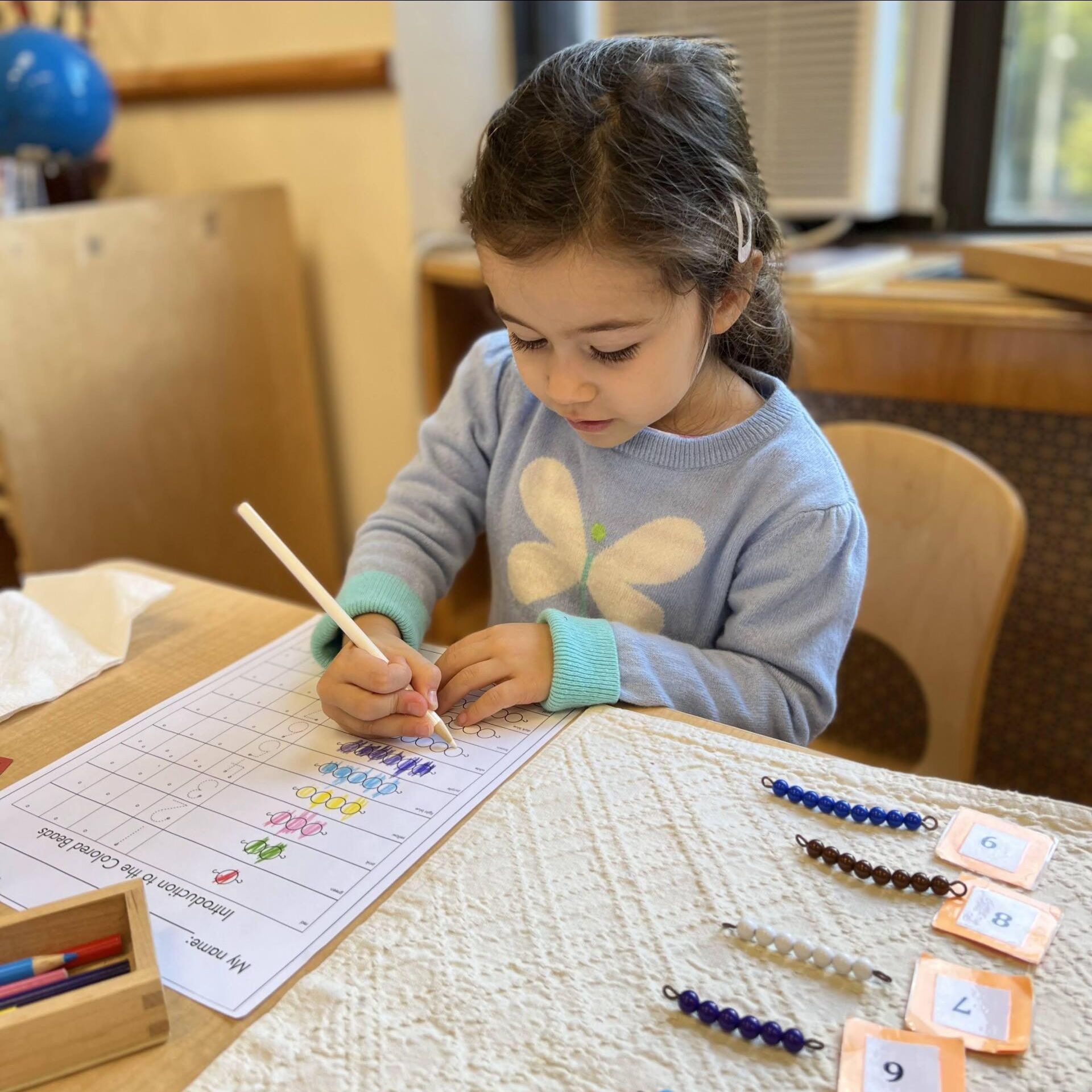 Child working with Montessori math materials