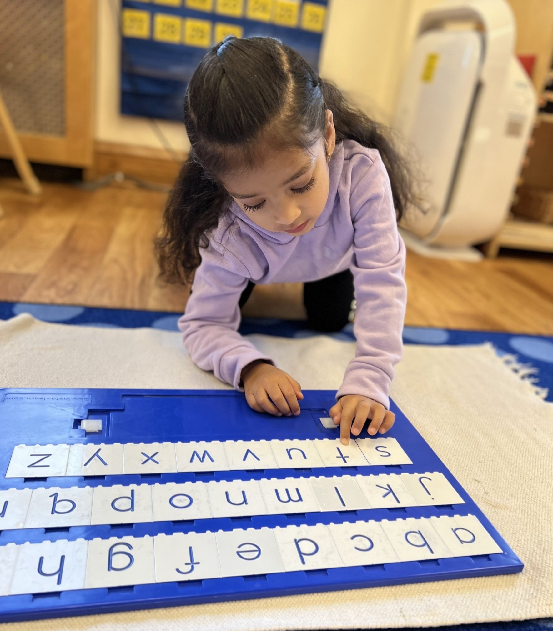 Child working with Montessori language materials
