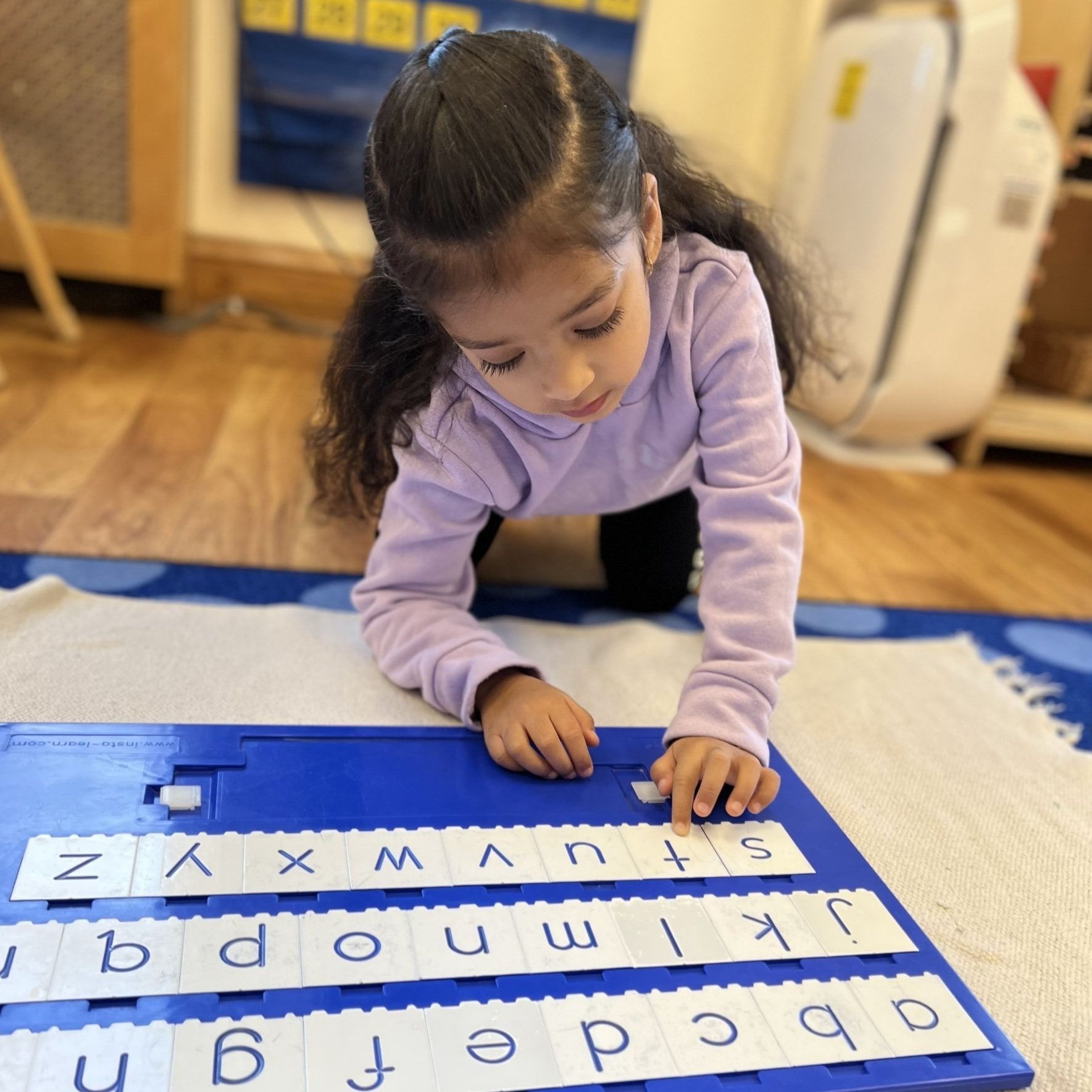 Child working with Montessori language materials