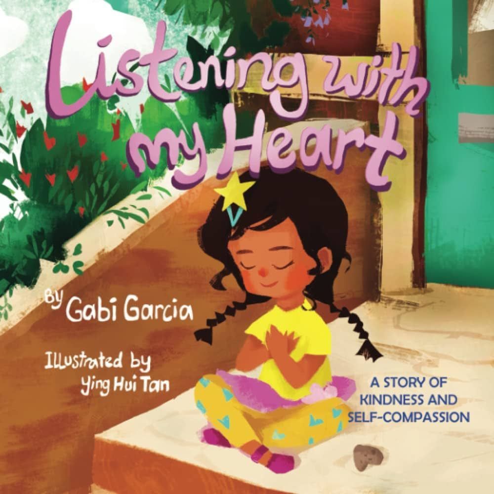 A girl sits with eyes closed, heart hands, beside a stone. Book cover,