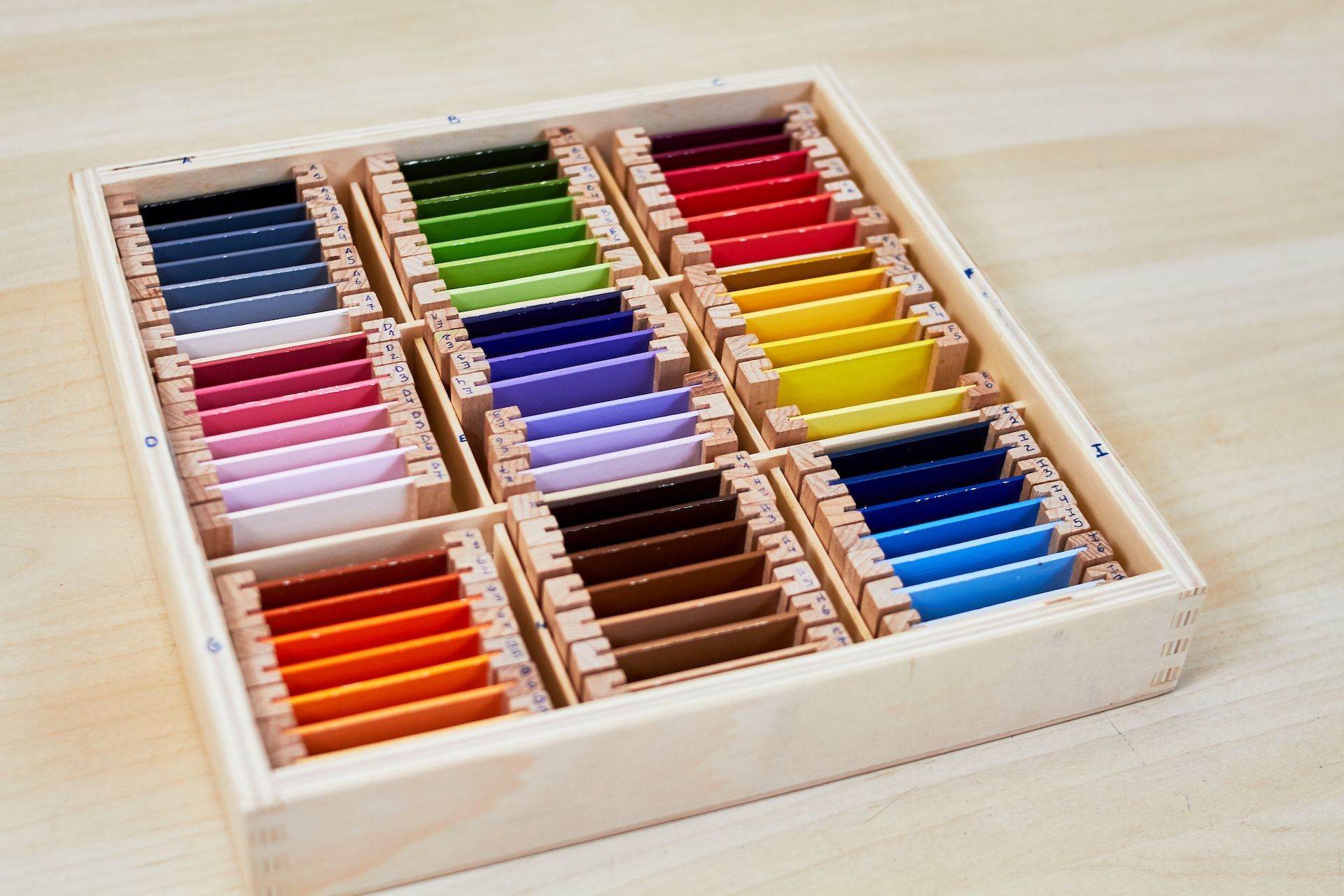 Wooden box with fabric color swatches in a variety of shades.