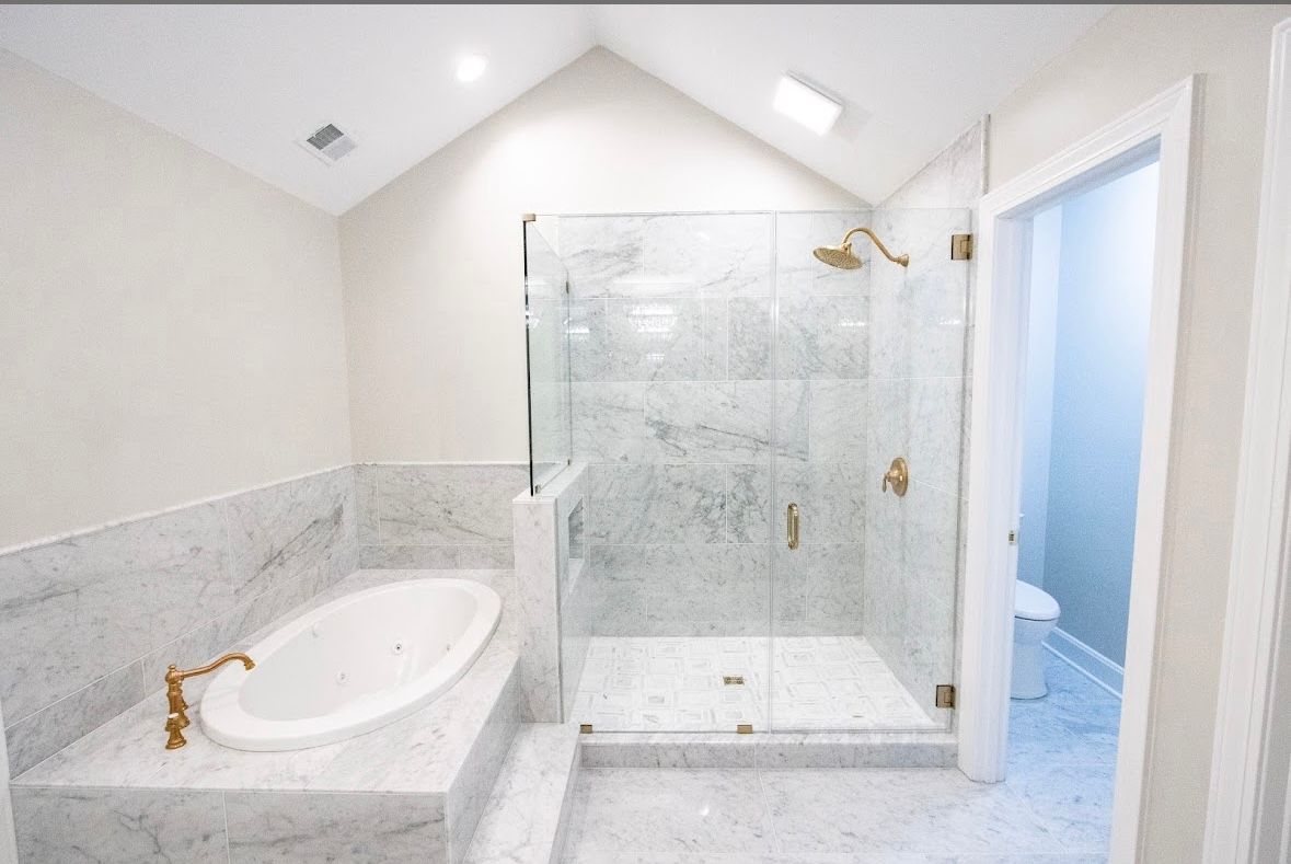 A bathroom with a toilet , sink , shower and mirror.