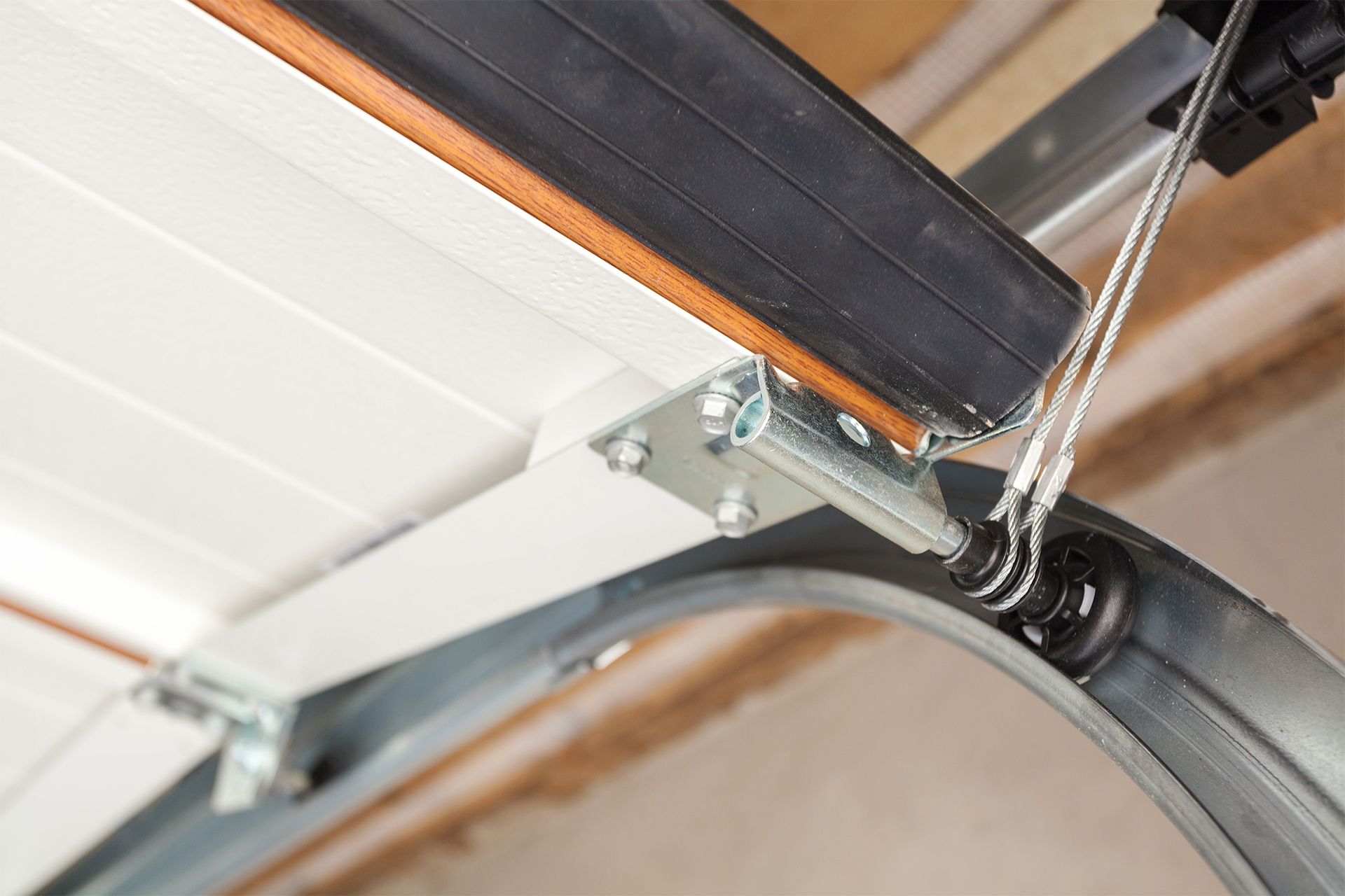 Garage door mechanism, showing track, springs, and door panel close-up