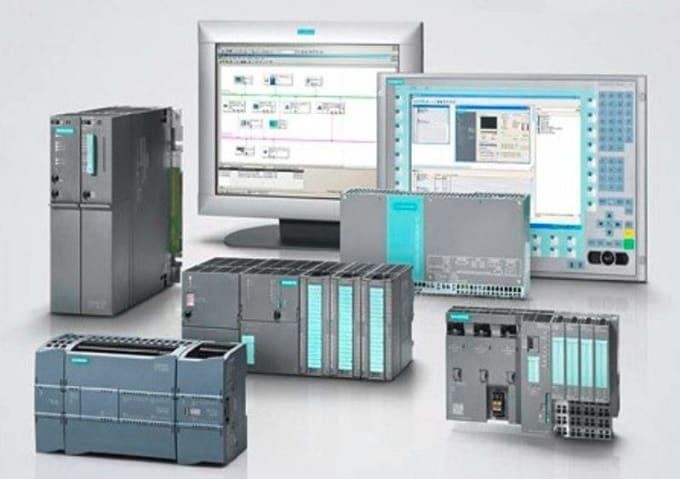 Automation equipment with monitors displaying control interfaces.