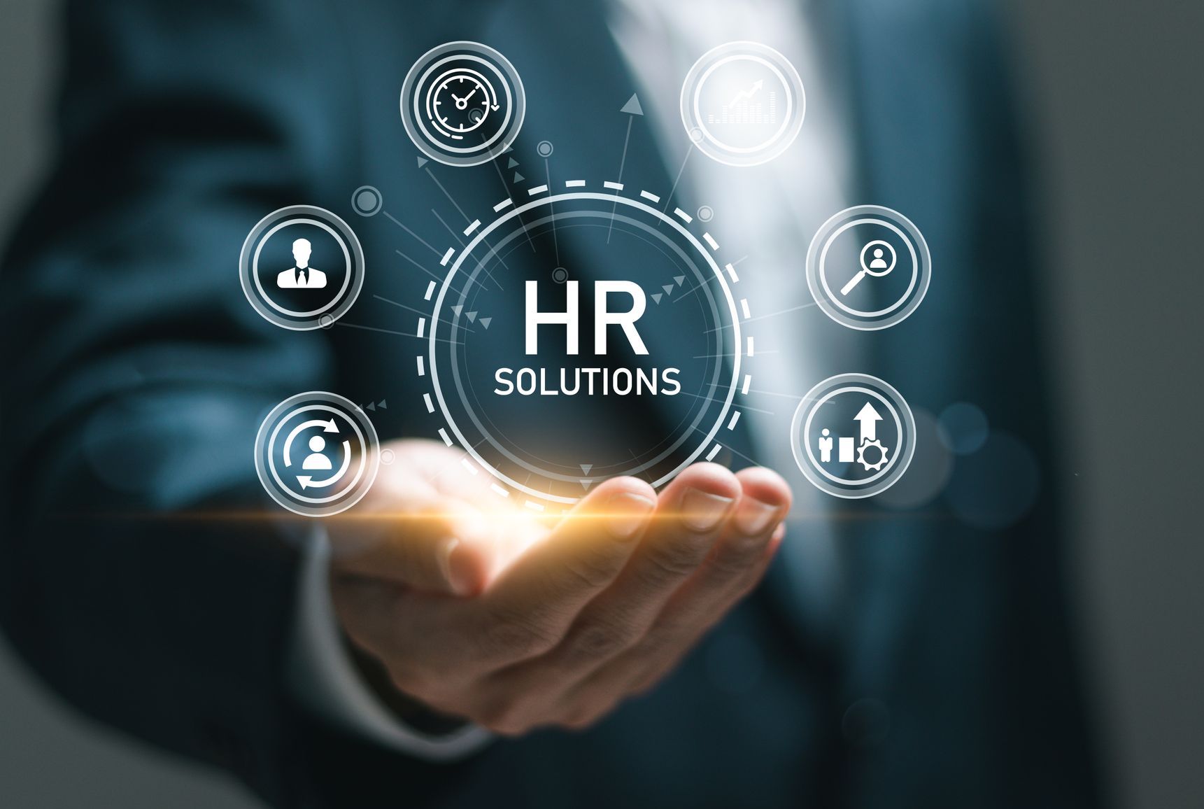 A man in a suit is holding a hr solutions icon in his hand.