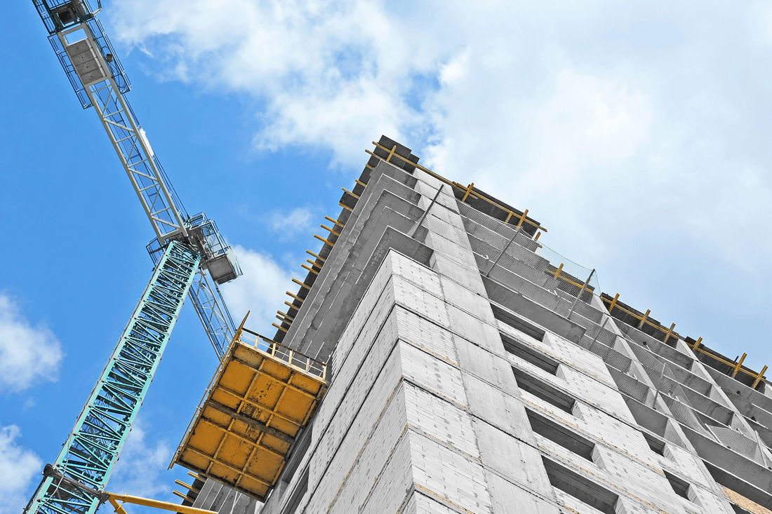 A building is being built with a crane in the foreground.
