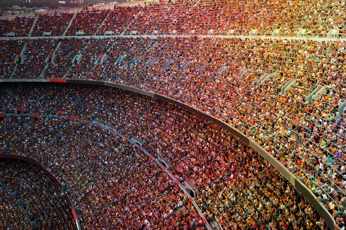 An aerial view of a stadium filled with people watching a game.