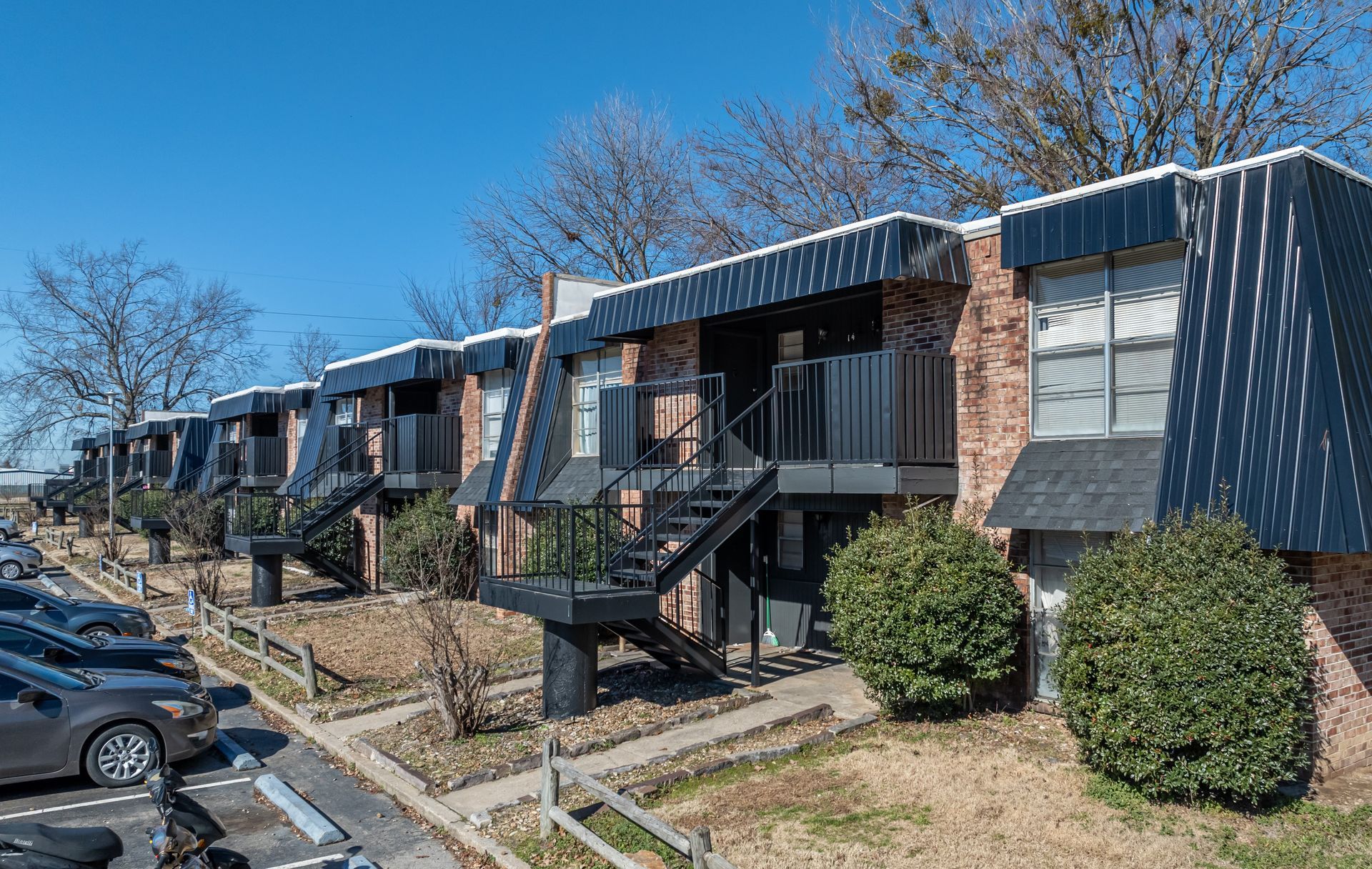 photo showing some unit entrances, staircases and parking lot