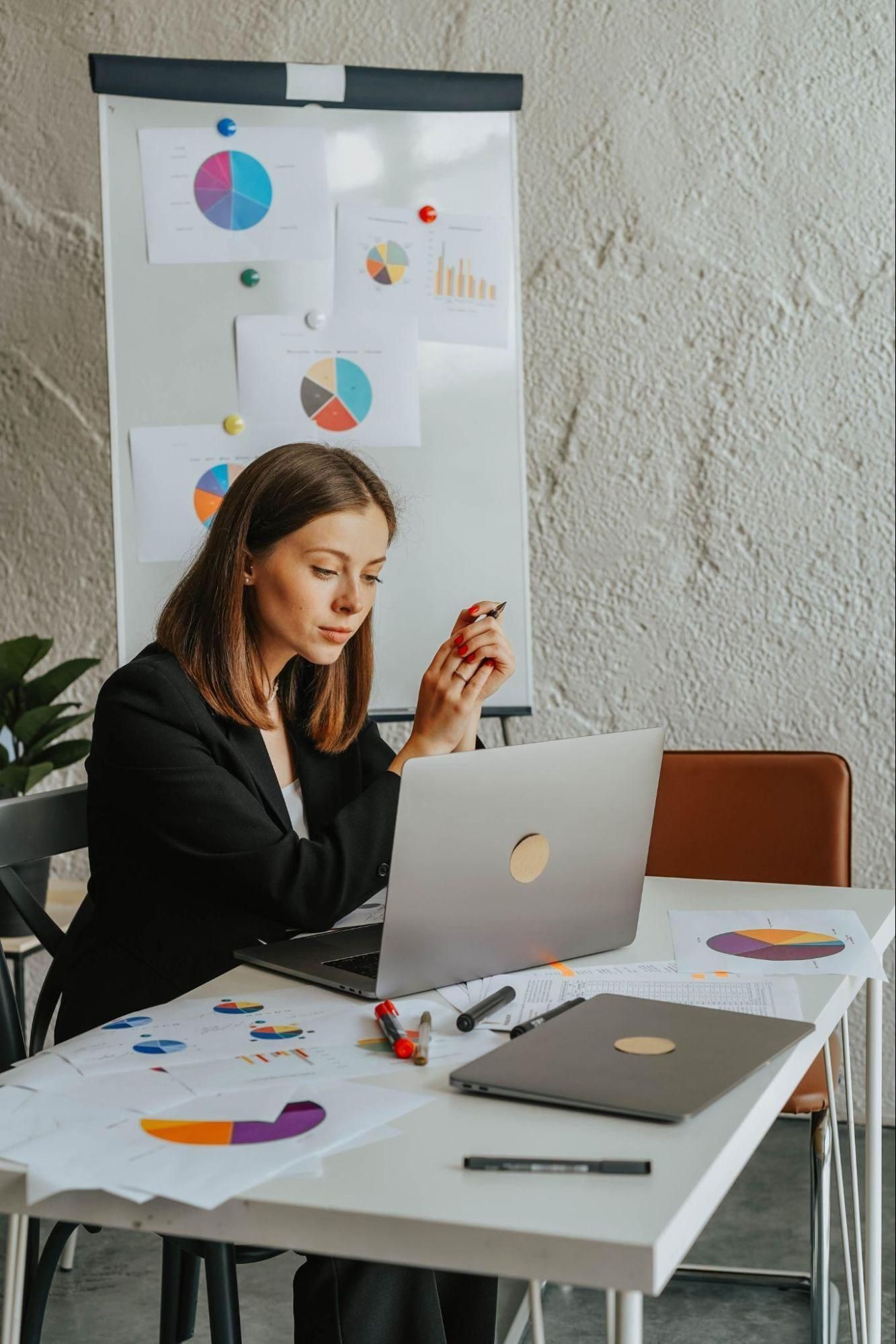 Employee analyzing workforce metrics and leading indicators of employee performance.
