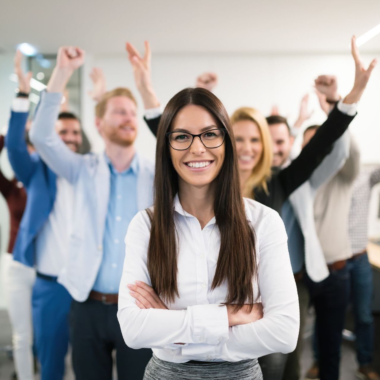 Happy team members standing next to a team leader