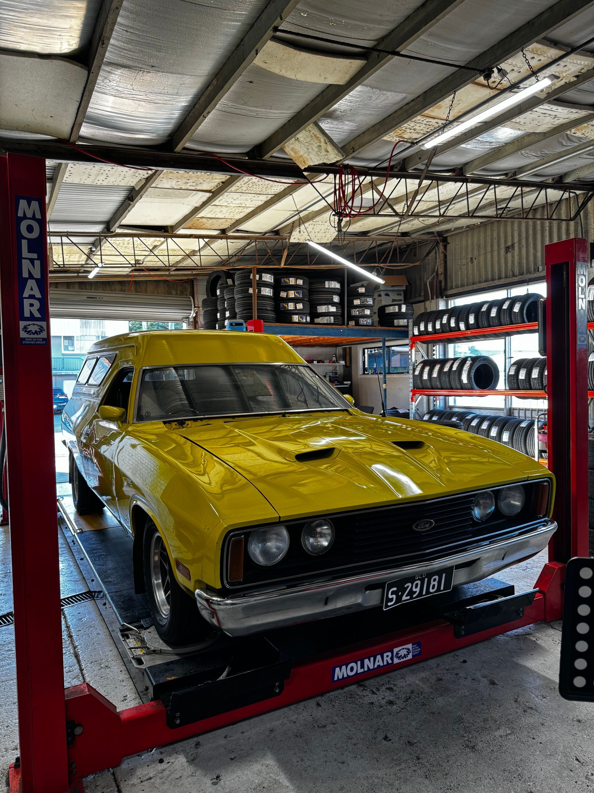A  Car on A Red Molnar Lift in A Garage — Jakes Tyres in South Murwillumbah, NSW