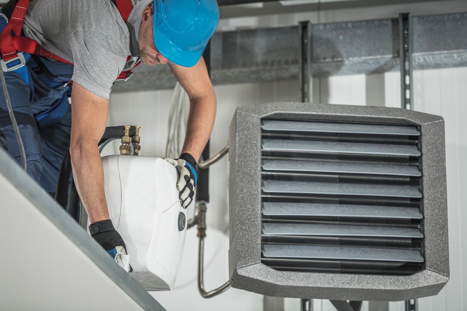 HVAC specialist performing air duct cleaning and maintenance service
