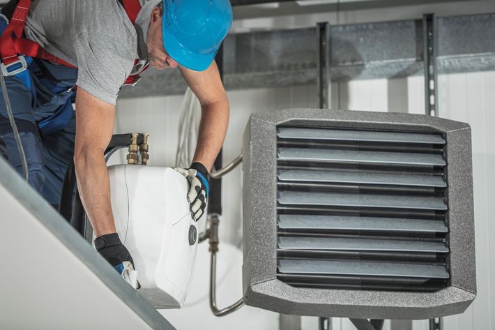 HVAC specialist performing air duct cleaning and maintenance service