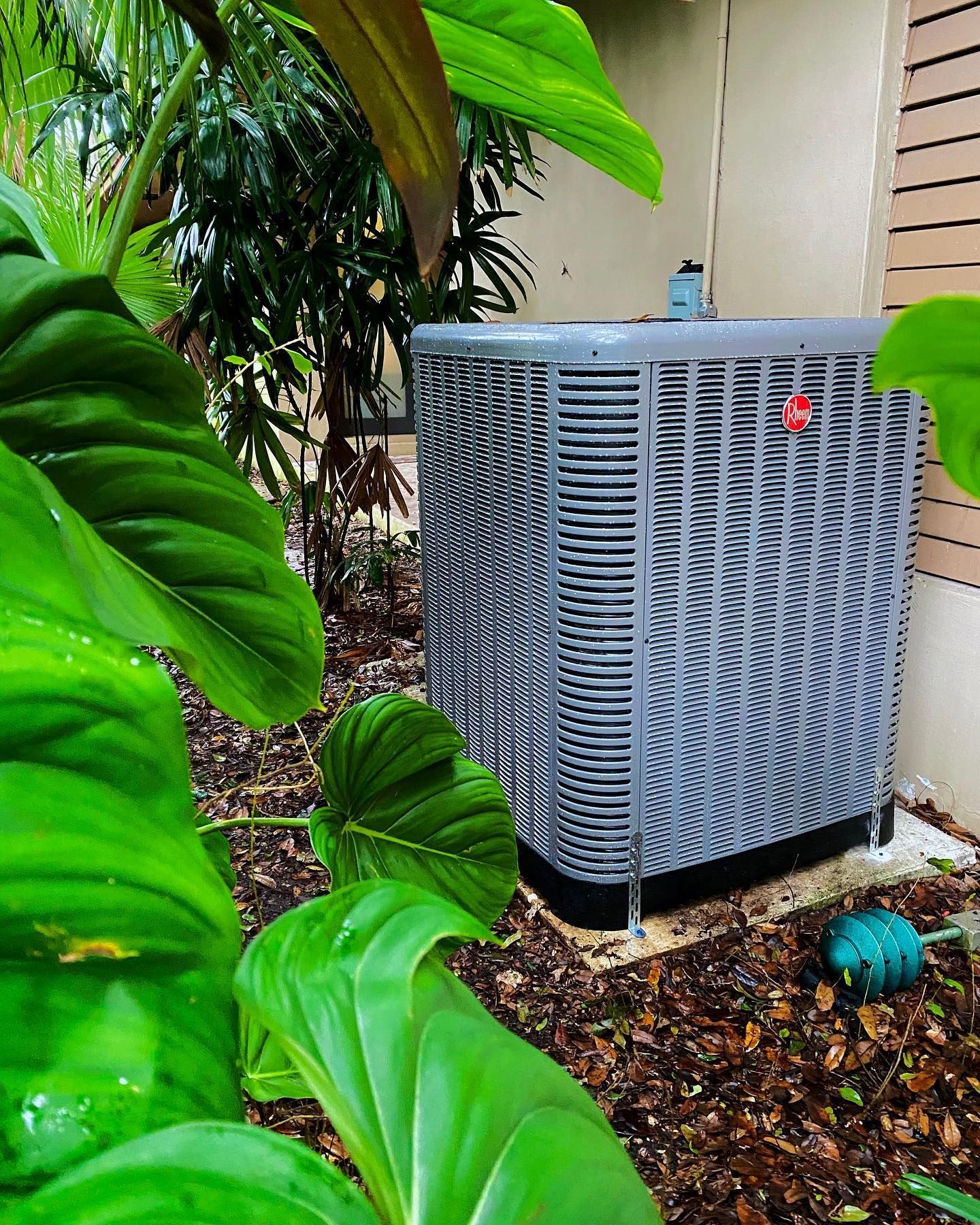 Outdoor Rheem air conditioning unit installed for residential cooling system