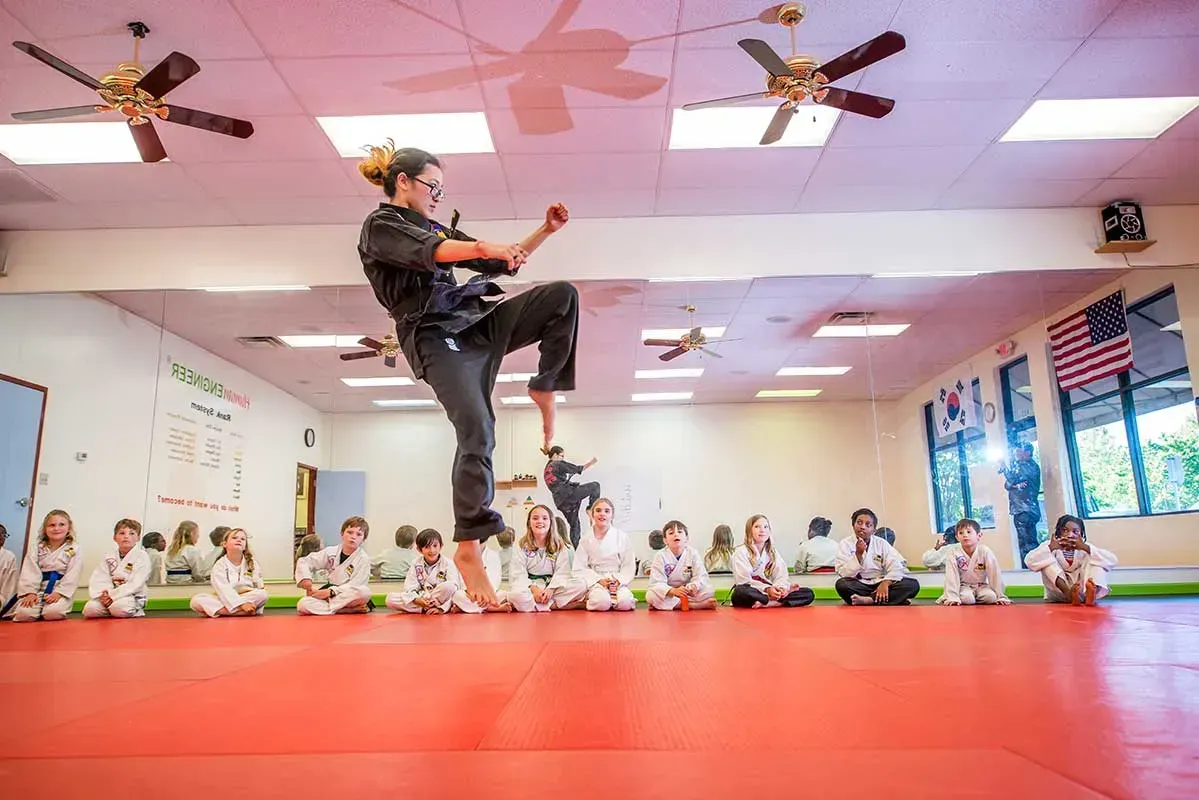 Martial arts instructor in mid-air kick