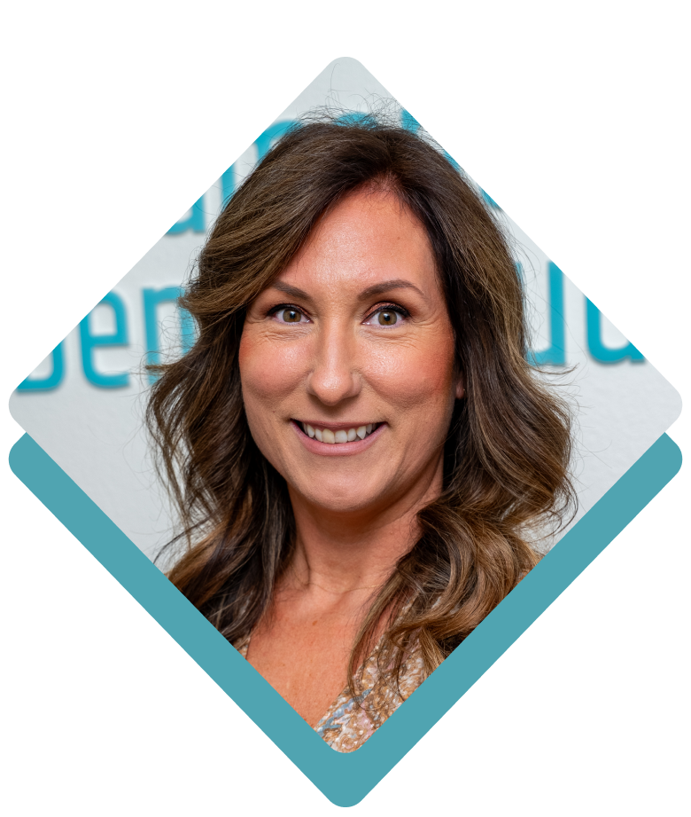Woman with brown hair smiling, set in turquoise diamond-shaped frame, in front of a blurred white backdrop with blue text.