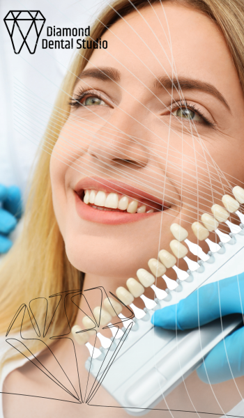 Woman at dentist comparing tooth shades for whitening treatment.