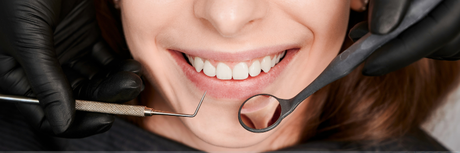 Clear aligners scattered on a white surface, a diamond logo with