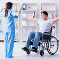 Caregiver and wheelchair user reach for items on shelves in a bright rehabilitation room