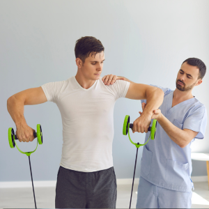 Physical therapist guiding a man using green resistance bands during arm exercise.