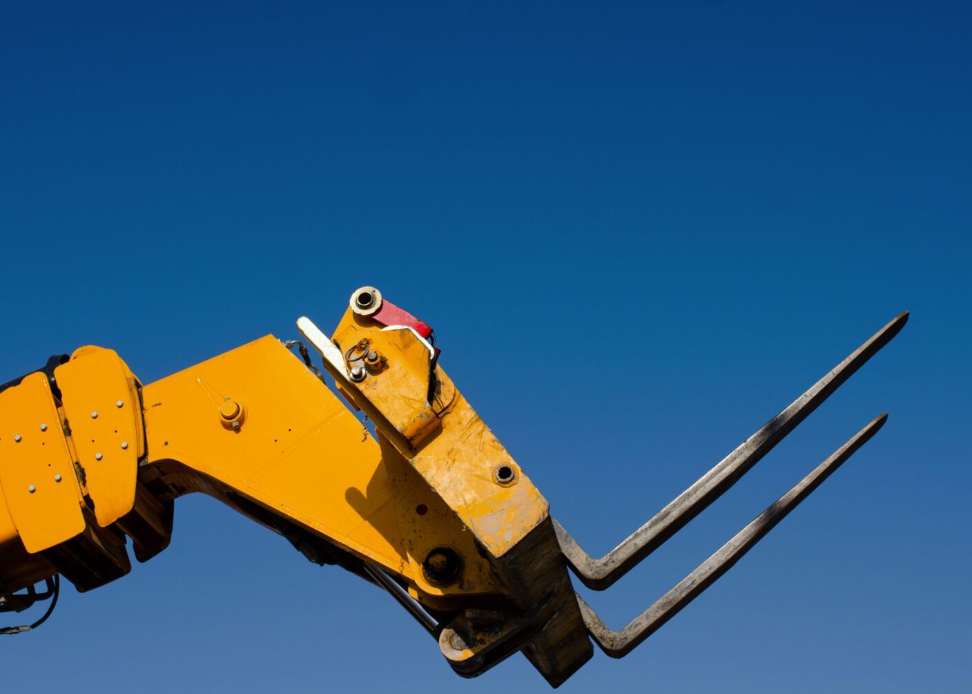 Yellow Forklift Forks Against a Bright Blue Sky — A1 Forklifts In Nambucca Heads, NSW