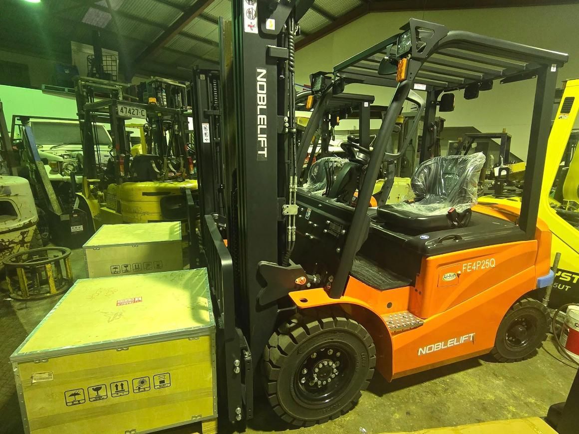 Forklift Lifting a Wooden Crate in a Warehouse — A1 Forklifts In Maclean, NSW