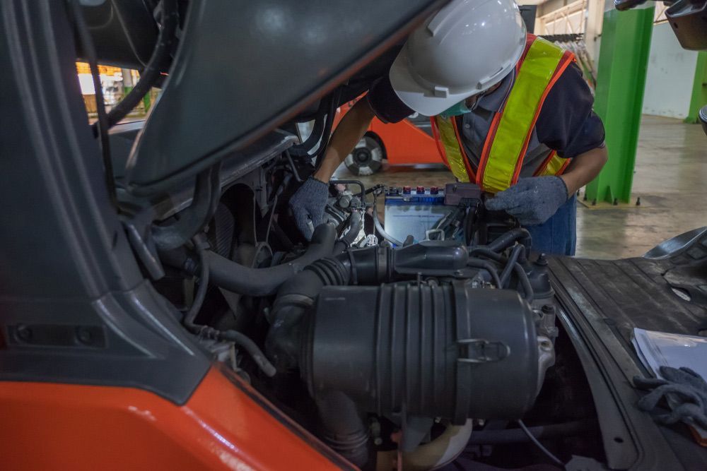 Mechanic Check the Gasoline Leaks in the Forklift — A1 Forklifts In Coffs Harbour, NSW
