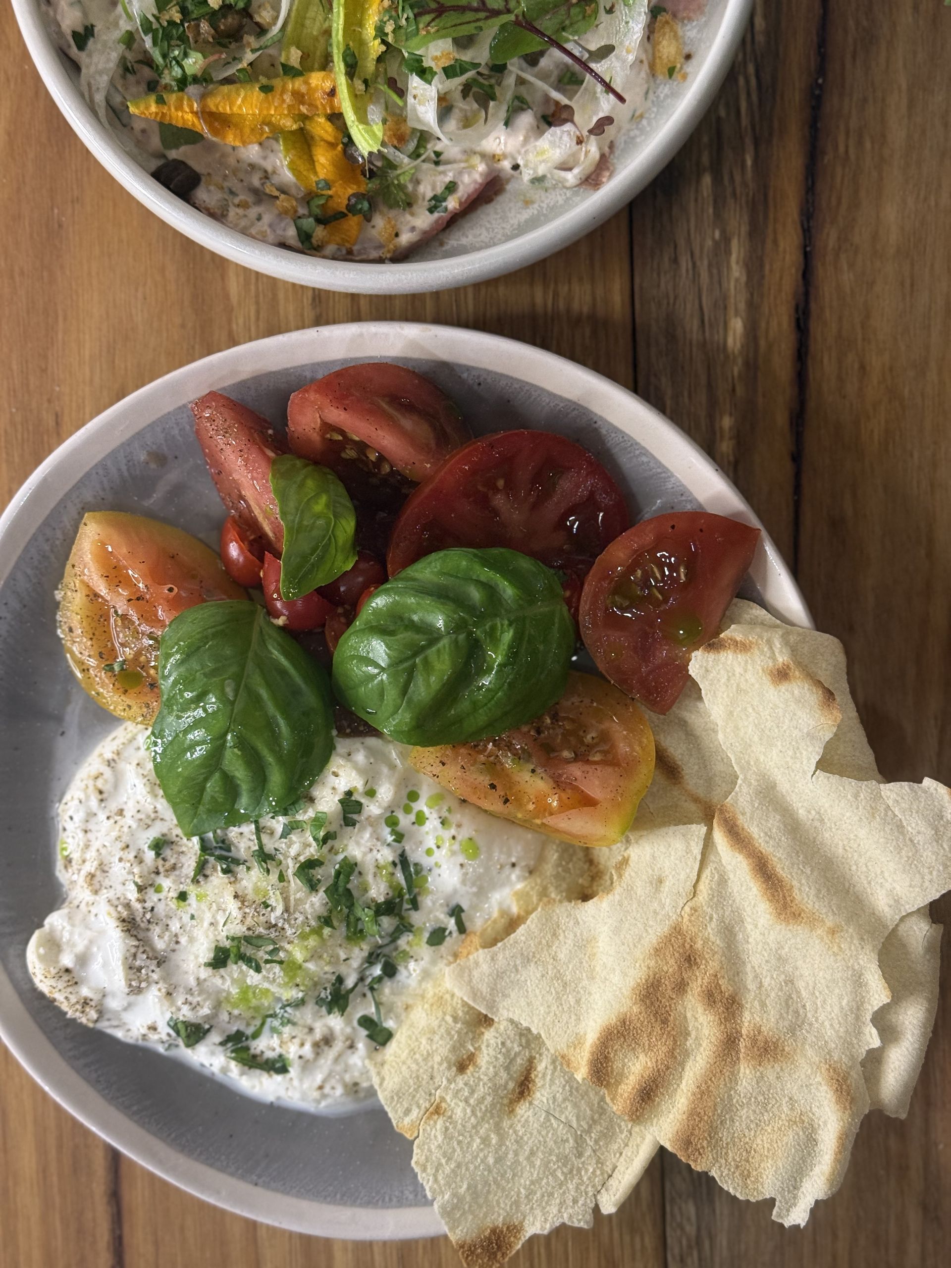 A plate with burrata and tomatoes— Onesta Cucina in Bowral, NSW