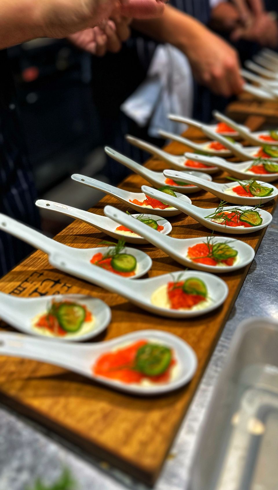 Lots of white spoons filled with food on a chopping board — Onesta Cucina in Bowral, NSW