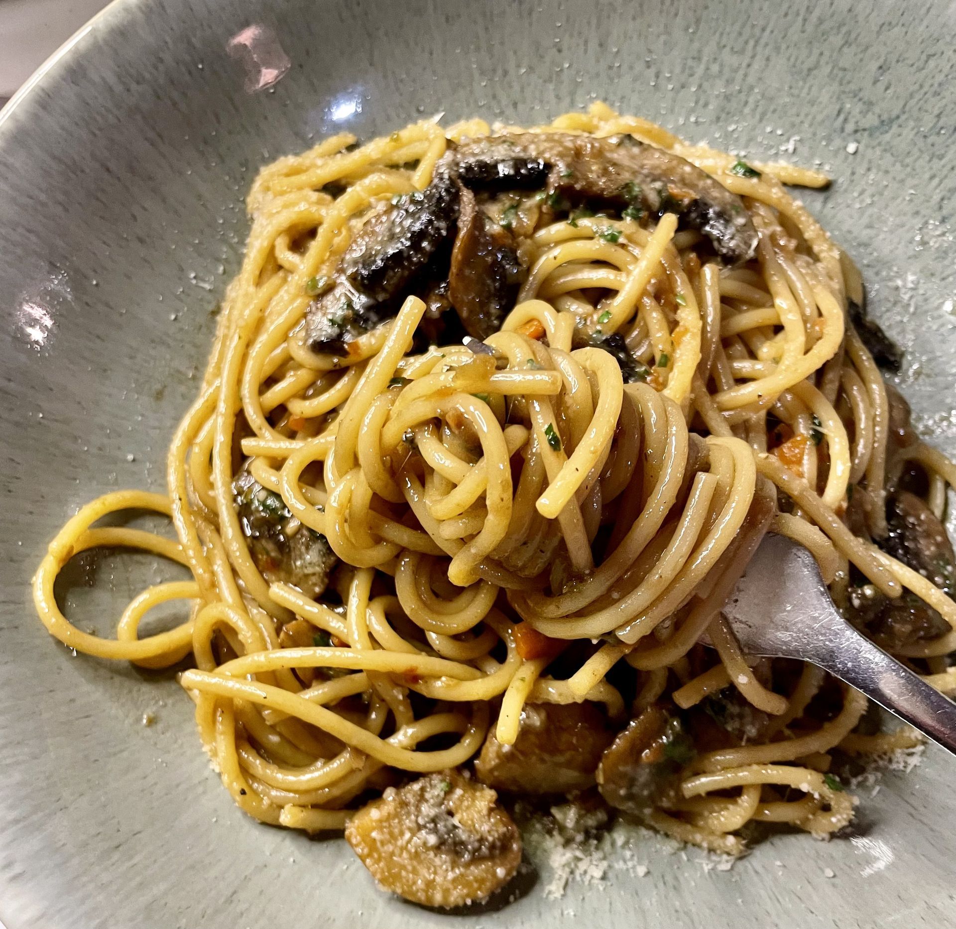 A bowl of spaghetti on a plate with a fork — Onesta Cucina in Bowral, NSW