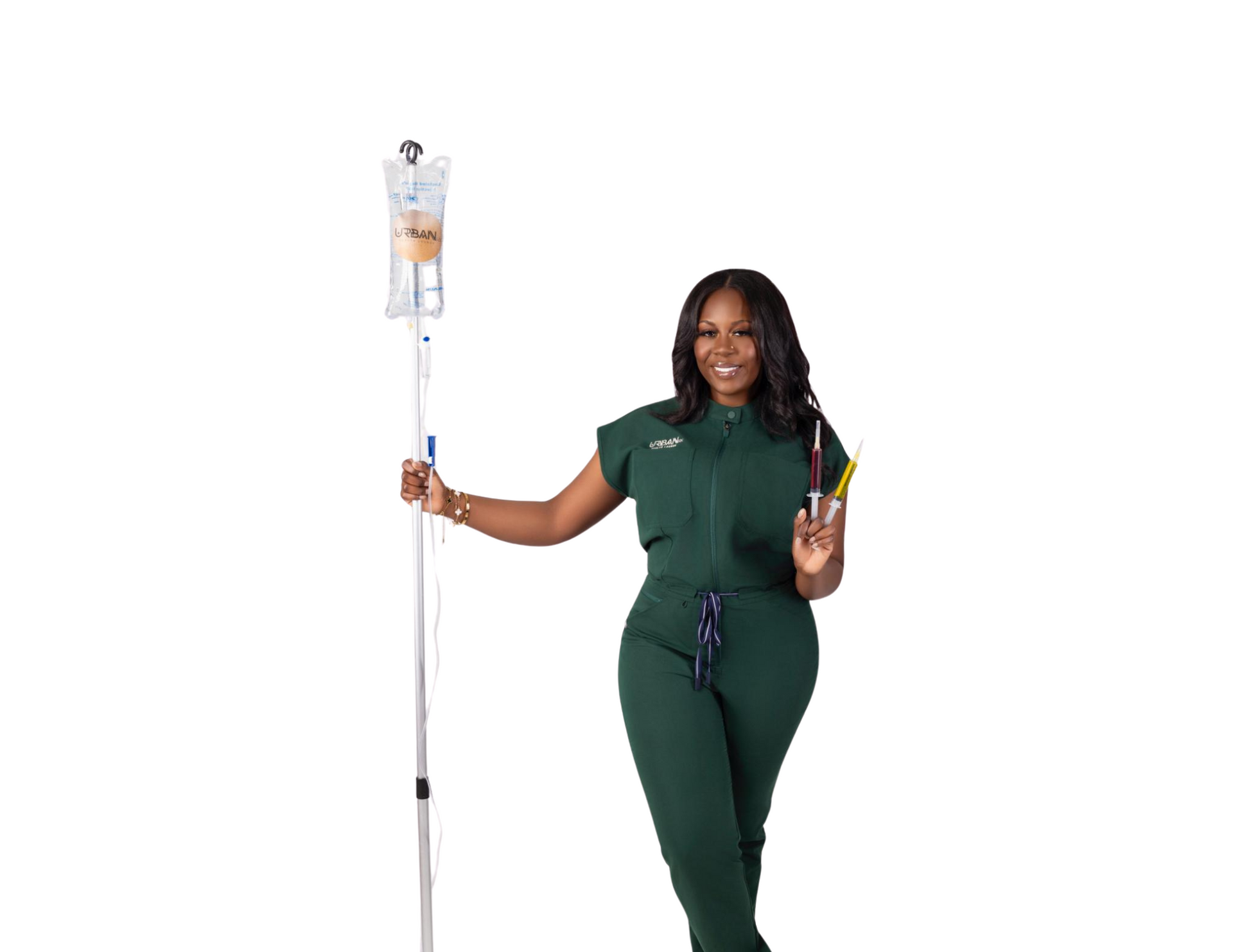 A smiling Black woman in green scrubs holds an IV stand, giving a peace sign. White background.