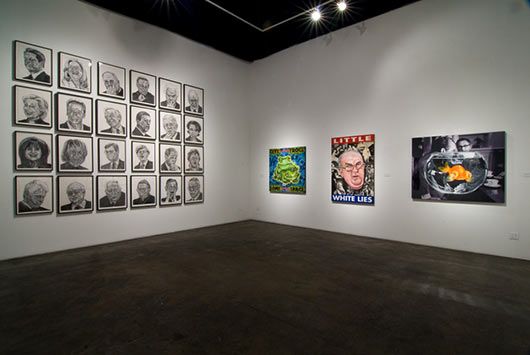 A room with a lot of paintings on the wall