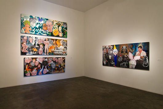 A room with a lot of paintings on the wall.