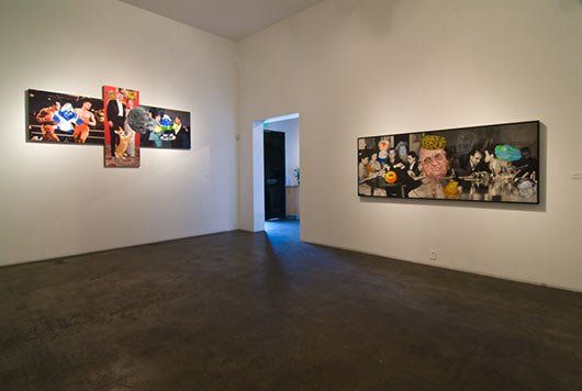 A room with a lot of paintings on the wall