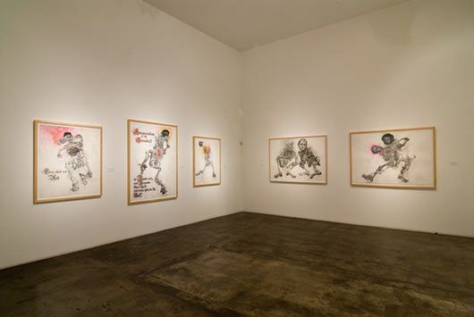 A room with a lot of paintings on the wall