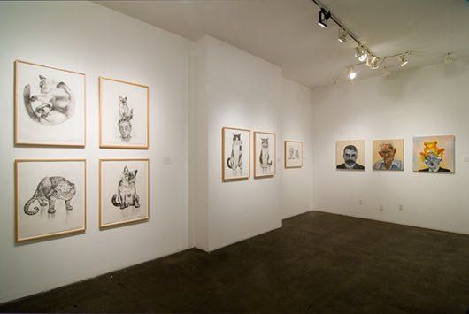 A room with a lot of paintings on the wall
