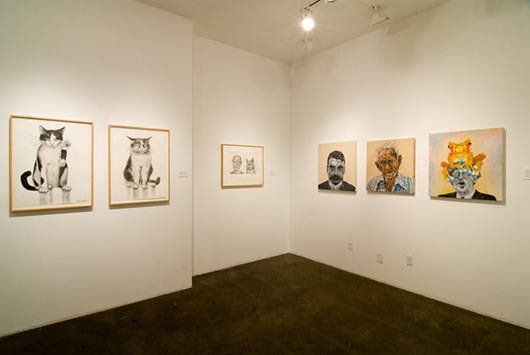 A room with a lot of paintings on the wall
