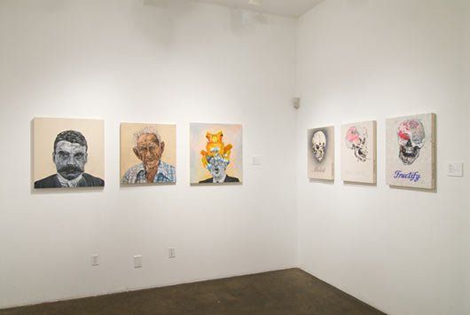 A room with a lot of paintings on the wall.