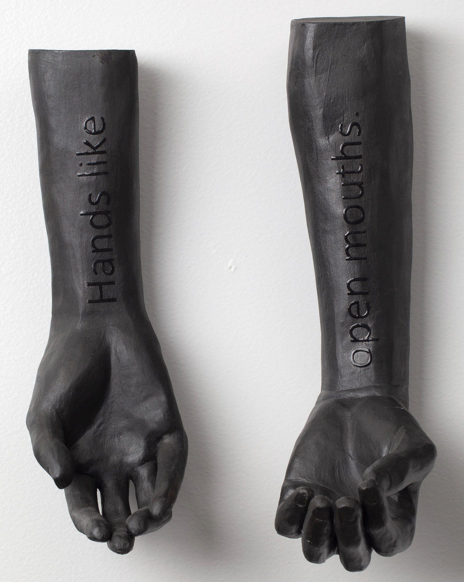 A pair of black hands that say hands like open mouths